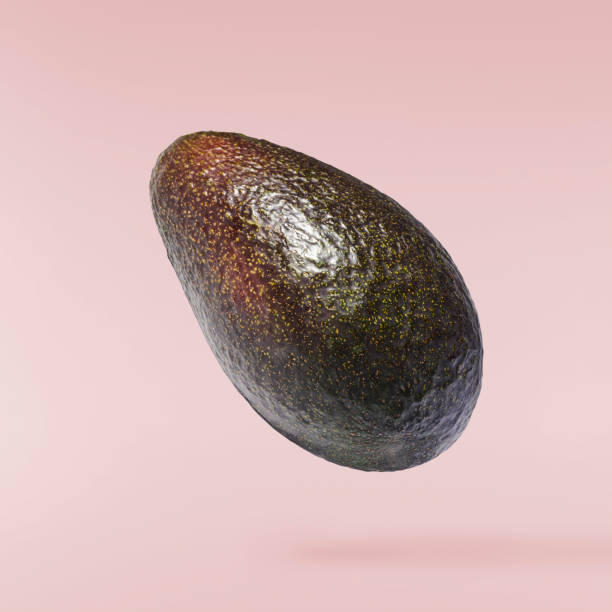 istock Fresh ripe avocado falling in the air isolated 2159952789