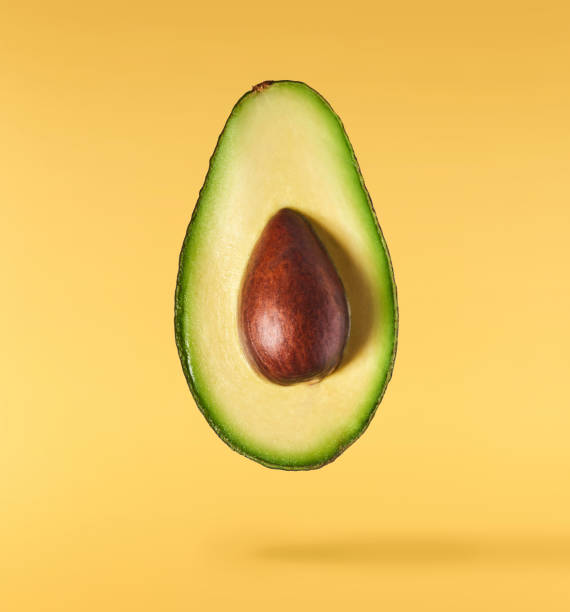 istock Fresh ripe avocado falling in the air isolated 2159952794