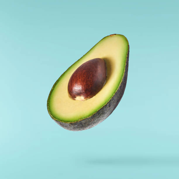 istock Fresh ripe avocado falling in the air isolated 2159952799