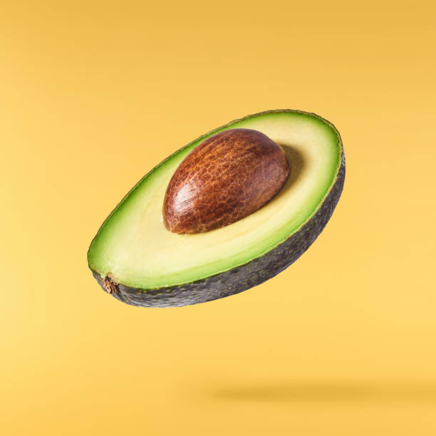 istock Fresh ripe avocado falling in the air isolated 2159952807