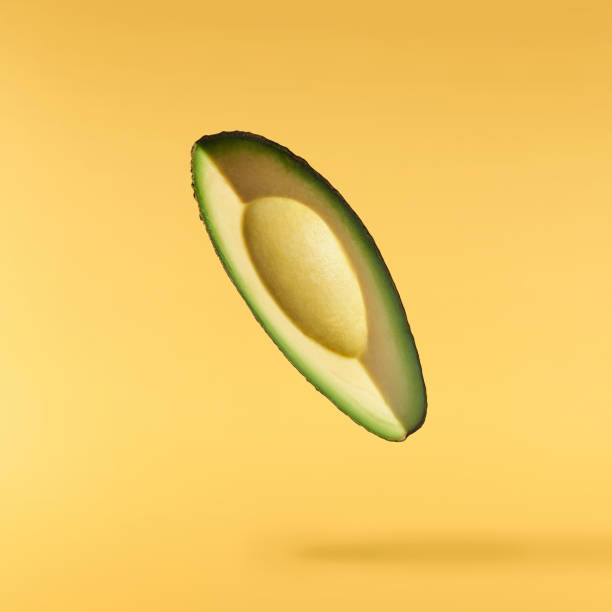 istock Fresh ripe avocado falling in the air isolated 2159952816