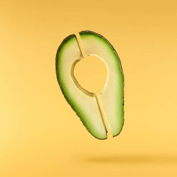 istock Fresh ripe avocado falling in the air isolated 2159952820