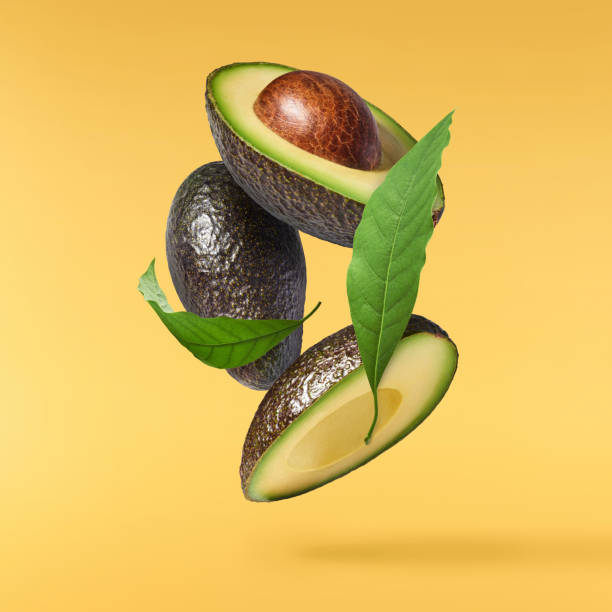 istock Fresh ripe avocado falling in the air isolated 2159952851