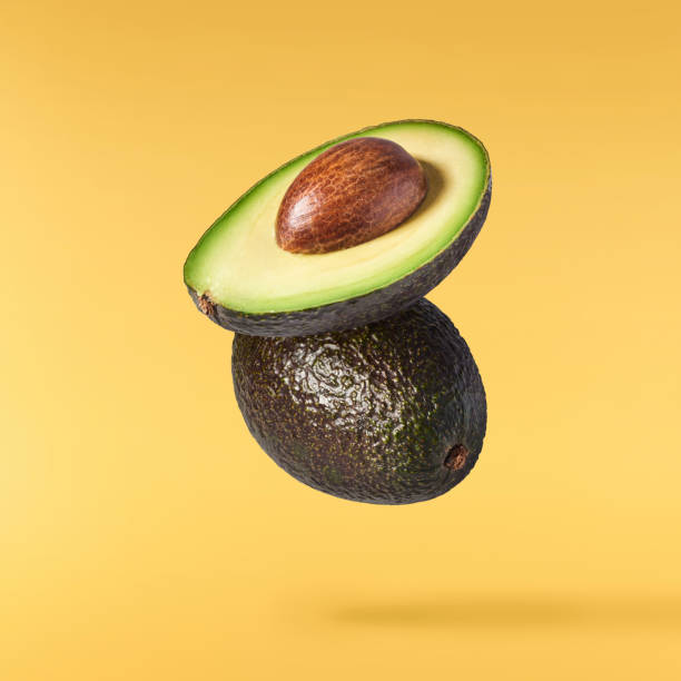 istock Fresh ripe avocado falling in the air isolated 2159952882