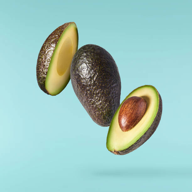 istock Fresh ripe avocado falling in the air isolated 2159952895
