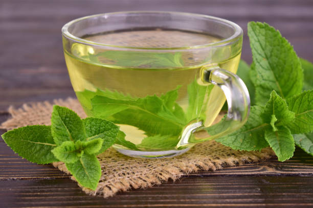 istock Cup of mint tea on a dark wooden background. Close-up. Selective focus. 2159953553