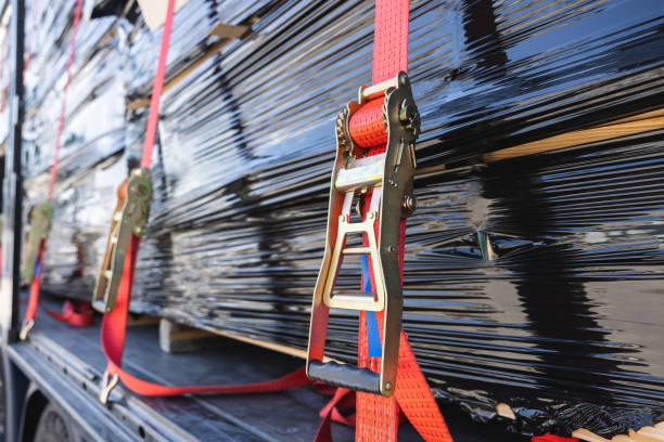 istock Secure cargo transport: Red ratchet strap on delivery truck. 2159953628