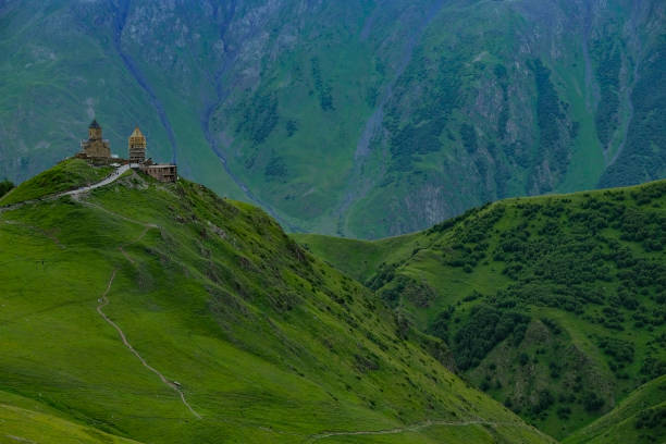 Stepantsminda, Georgia - June 30, 2024: Landscape with the Gergeti Trinity Church on Mount Kazbek in Stepantsminda, Georgia.