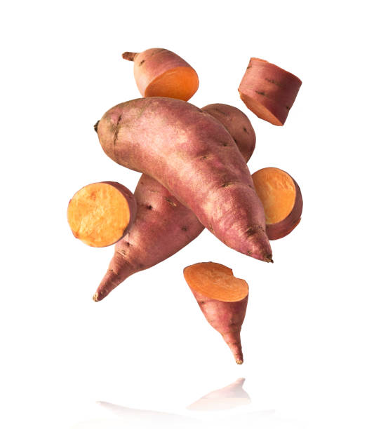 istock Fresh raw sweet potato falling in the air isolated 2159954422