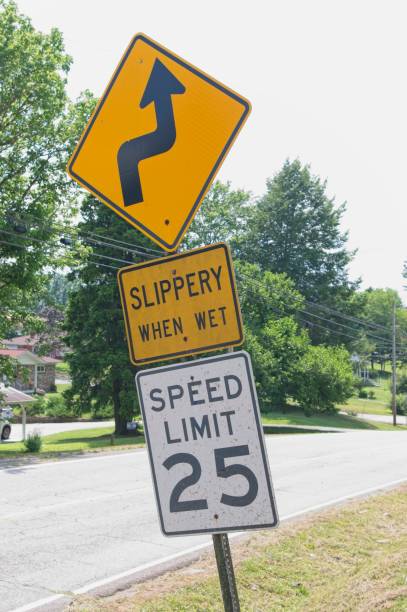 istock Slippery when wet sign with speed limit 2159956279