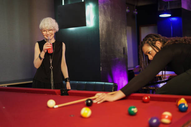 istock Multi ethnic friends playing billiards in bar 2159957389