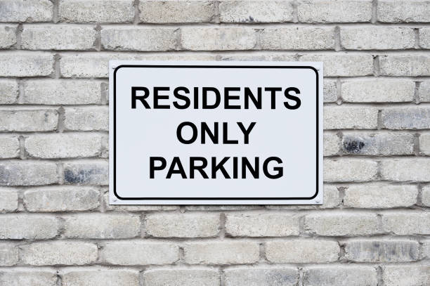 istock Residents only parking sign on wall at private housing development 2159960897