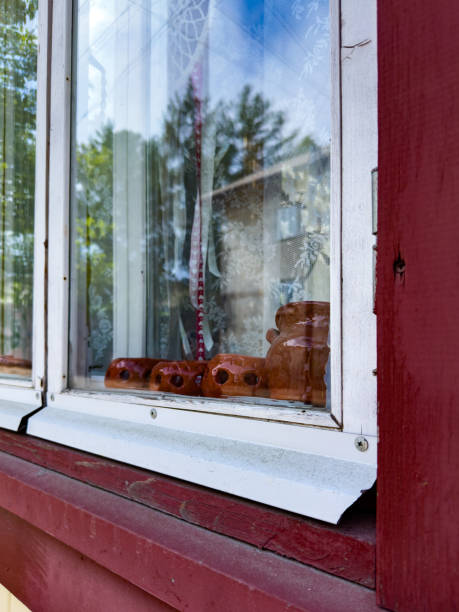 istock Rustic Window with Clay Figurines and Lace Curtains 2159961954