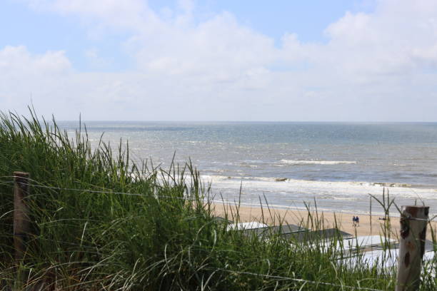 istock Green grass, calm Sea water, blue sky 2159962079