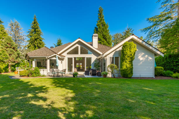 This home has large open concept room painted white with simple and stylish decor. The kitchen has expansive countertops and cupboards and cabinets with gold fixtures. Living room has wall mounted tv and an electric fireplace, the family room has 2 blue recliners and a wood burning fireplace. Rooms have multiple large windows with views to the garden and golf course beyond the backyard. Lush landscaping with mature trees. Bathroom is sparkling clean and white marble with free standing bath tub and open glass wall shower with gold fixtures.