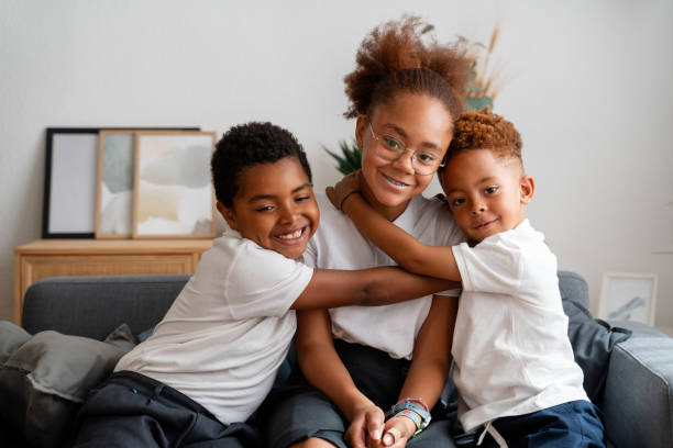istock pupils hugging on sofa at home after school 2159962799