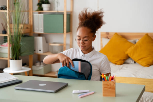 istock Young student girl packing backpack at home for school 2159963370
