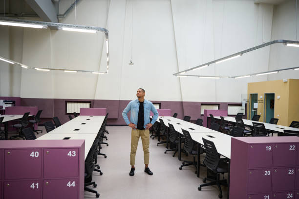 istock Calm young businessman standing in office while looking around it 2159964273