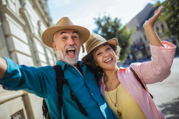 istock Elderly married couple exploring new city. Taking selfie 2159965283