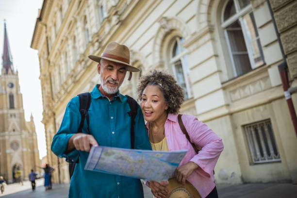 istock Elderly married couple exploring new city with map. 2159965298