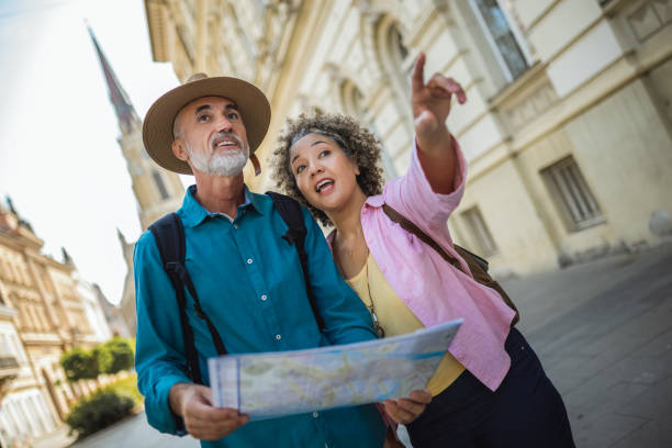 istock Elderly married couple exploring new city with map. 2159965326