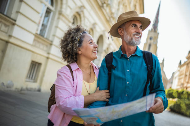 istock Elderly married couple exploring new city with map. 2159965332