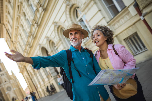 istock Elderly married couple exploring new city with map. 2159965340