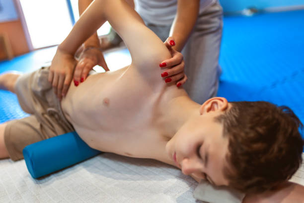 istock Therapeutic exercise kinesitherapy of little boy. 2159965935