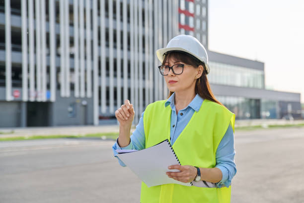 istock Industrial worker female builder with working documents, outdoor construction 2159966877