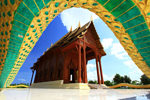 Wat Ao Noi temple with Great Naga surrounded temple and mountain in the background with blue sky, Prachuap Khiri Khan, Thailand
