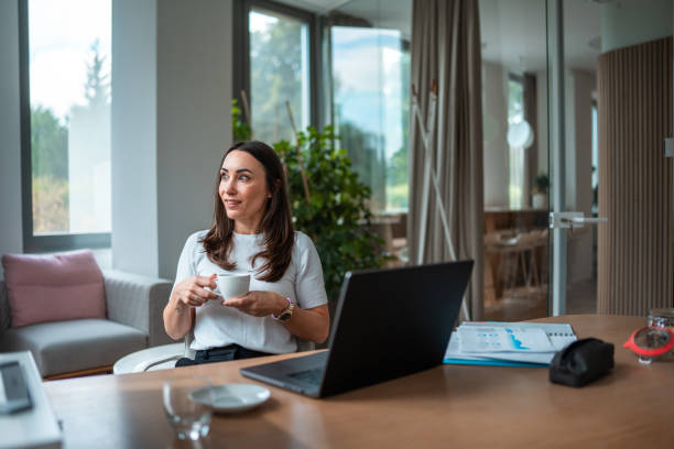istock Professional Businesswoman Multitasking in Modern Workspace 2159972106