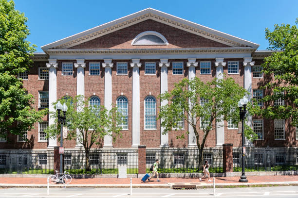 Unnoticed by themselves, two Harvard students travel to the beat of the same drum as they pass by Lehman Hall at Harvard Square.