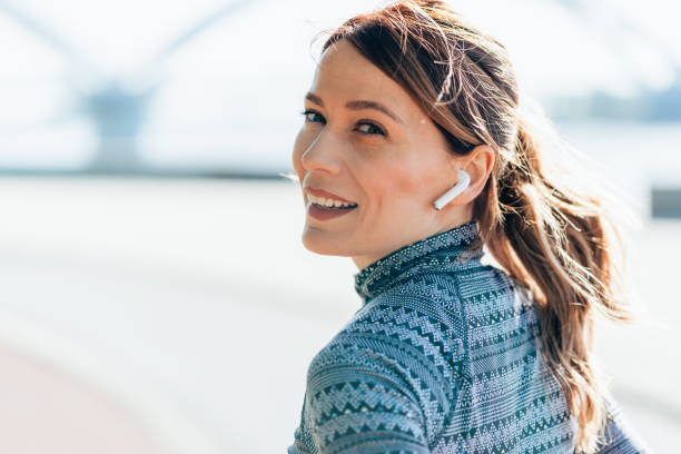 istock Happy sportswoman with earbuds running 2159976694