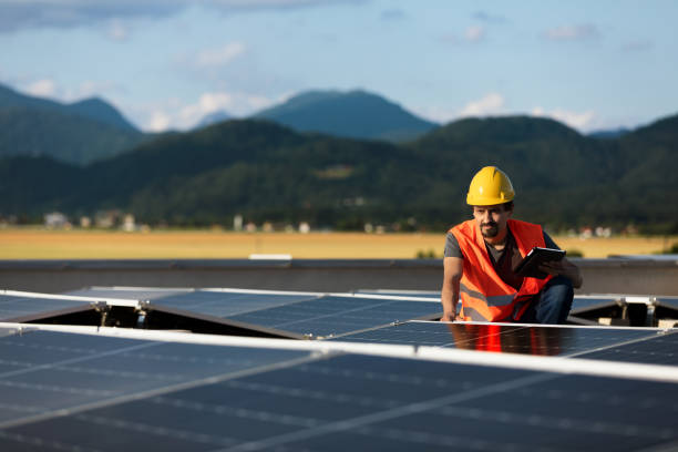 istock Technician using tablet and checking solar power plant installed on building roof 2159977732