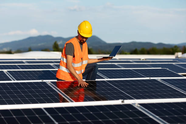 istock Technician using tablet and checking solar power plant installed on building roof 2159977742