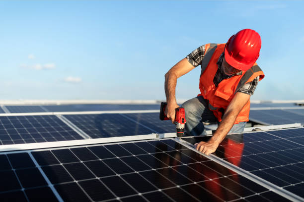 istock Technician installing solar panel on roof of a building 2159977757