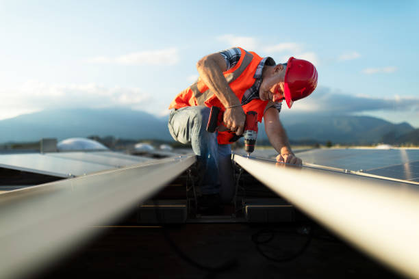 Technician installing solar panel on roof of a building