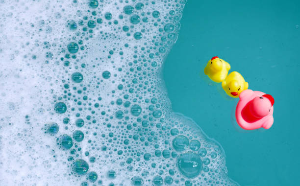 istock Rubber ducks in water with soap foam 2159986271