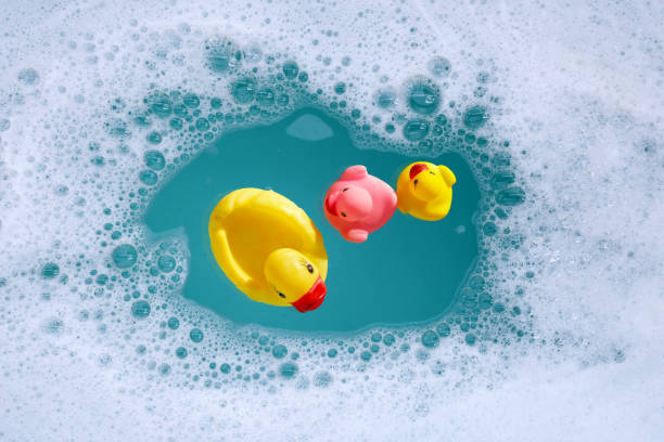 istock Rubber ducks in water with soap foam 2159986280