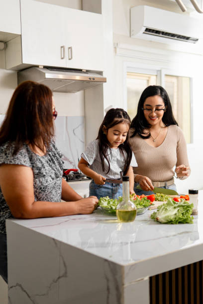 istock Hispanic Family Cooking Together in Home Kitchen 2159986812