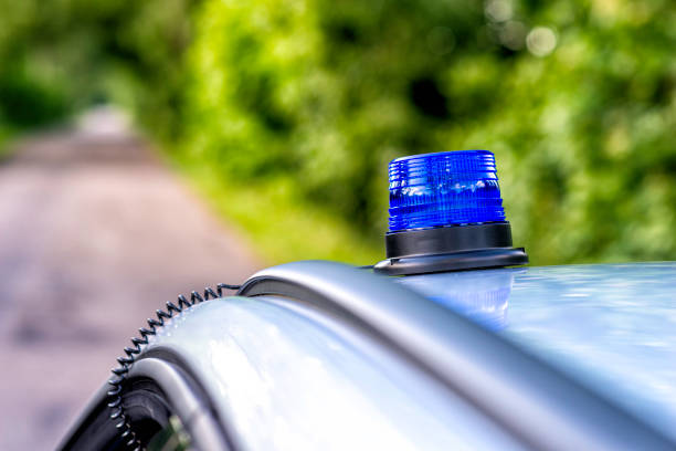 Germany, Berlin, Potsdamer Platz, July 27, 2024 - Close-up of blue flash light of a police car against people on a city street