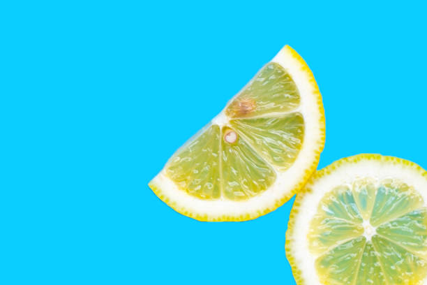 istock Fresh lemon slices on blue background. 2159987503