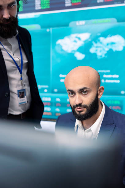 istock Financial analyst works on resource allocation plans with his staff 2159988846