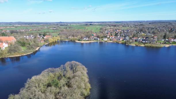 istock Drone view of a small lake in low sun surrounded by fields and woods. 2159990550