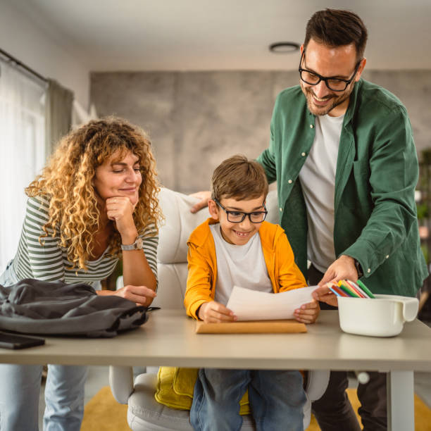 istock Mom and dad help son to do homework after school 2159992050