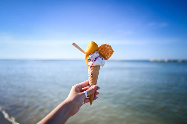 istock Holding Ice Cream On The Beach 2159992108