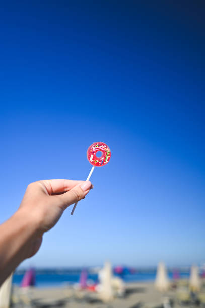 colorful lollipop in a hand.