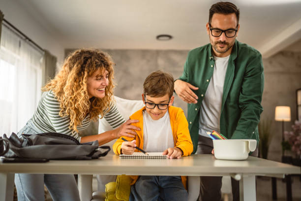 istock Mom and dad help son to do homework after school 2159992911