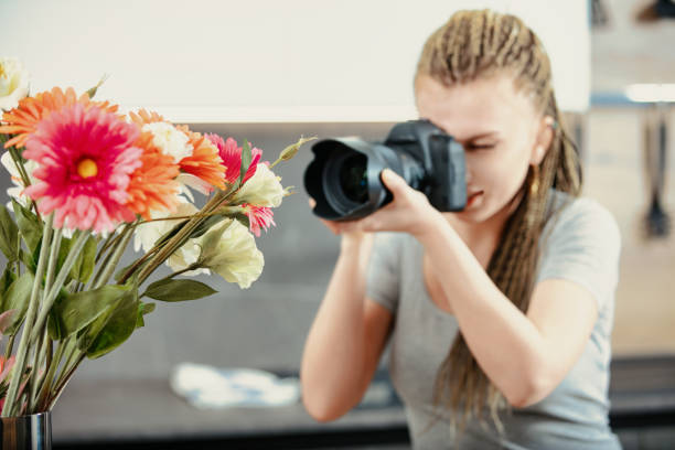 istock Photographer focuses on flowers, subject in sharp. 2159993070