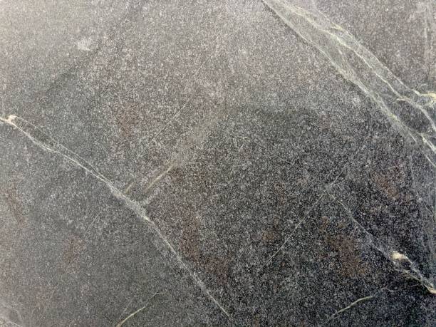 A polished granite marble kitchen surface exudes luxury and elegance, with its smooth, gleaming finish and intricate patterns, enhancing the interior design with timeless beauty and sophistication.